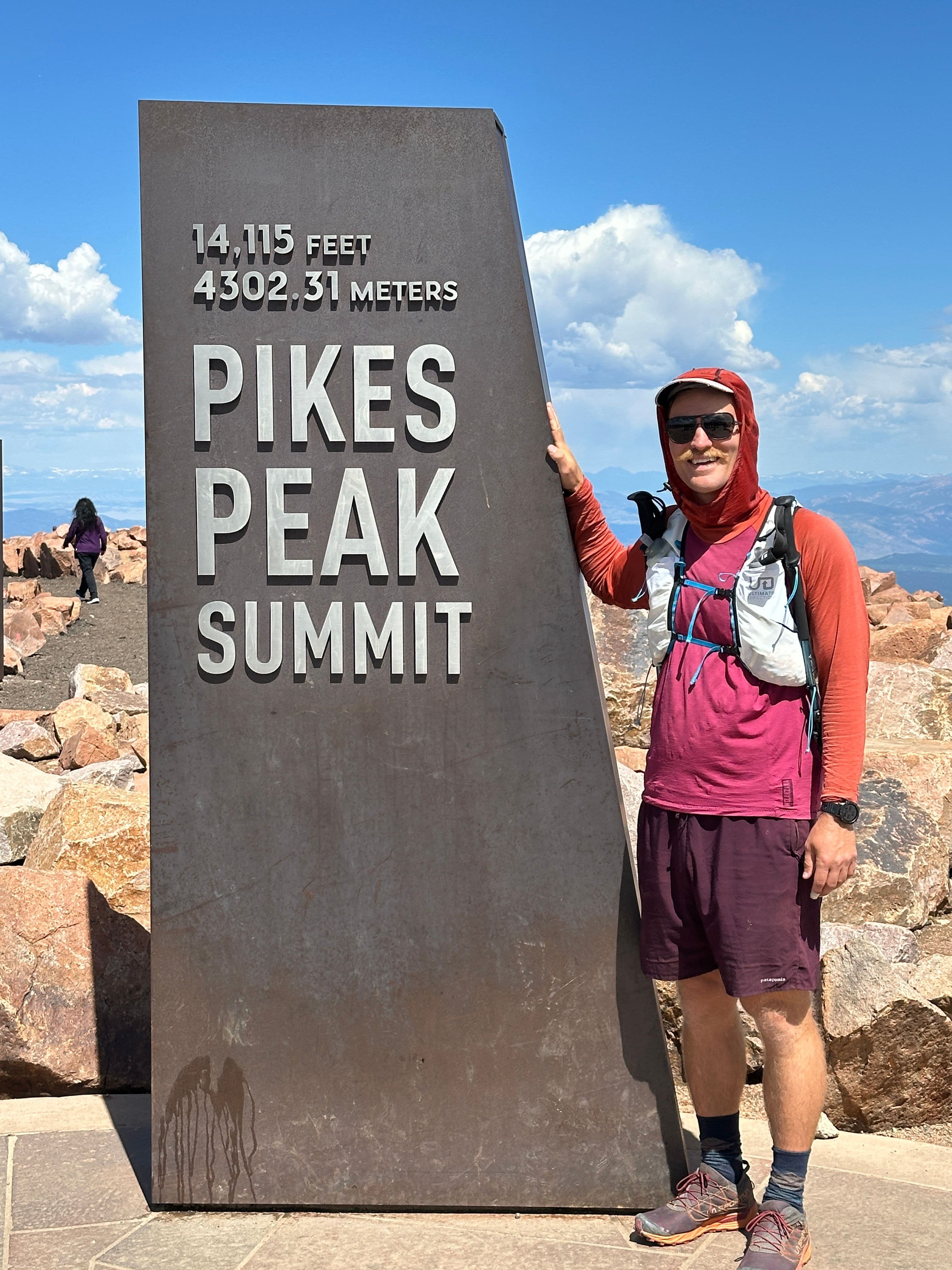 Spencer at the pikes peak summit marker.
